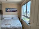 Bedroom with large window and city view