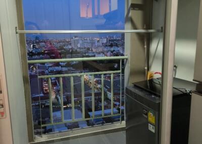 Small balcony with a city view at dusk