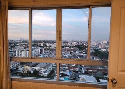 Bedroom with large window offering city view