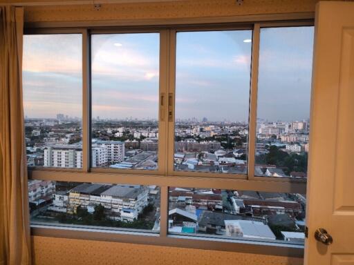 Bedroom with large window offering city view