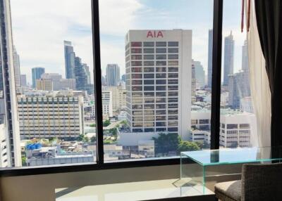 Modern bedroom with a large window and city view