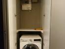 Compact laundry area with washing machine and storage