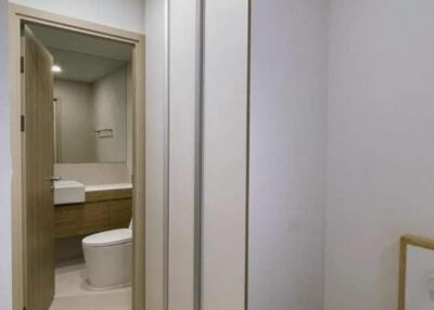 View of bathroom entrance with wardrobe and stool