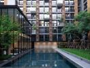 Modern apartment building with outdoor swimming pool and landscaped garden