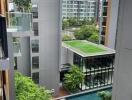 View of modern apartment buildings with a swimming pool and green rooftop garden