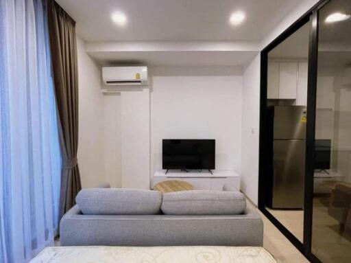 Modern living area with large windows and air conditioning