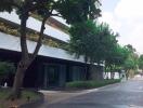 Exterior view of a building with trees and a driveway