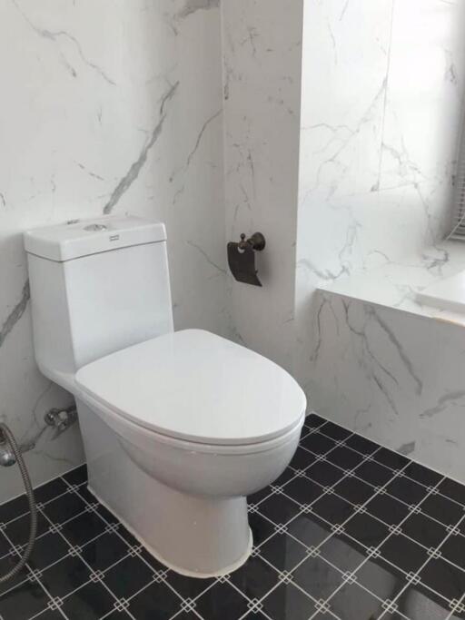 Modern bathroom with tiled floor and marble walls