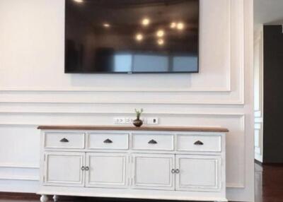 Living room with mounted TV and white cabinet