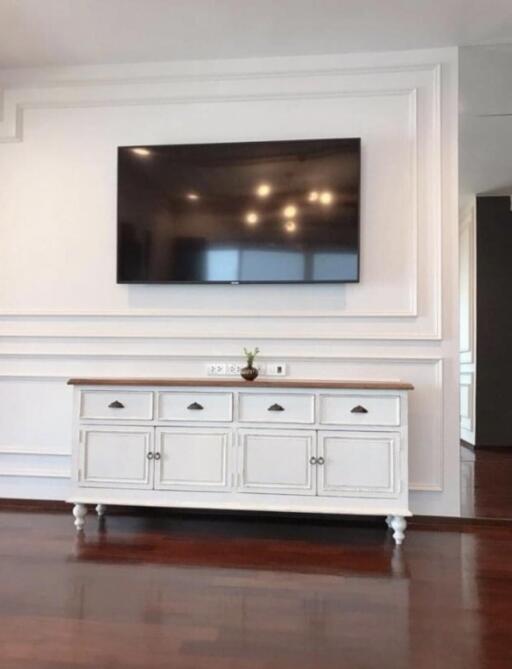 Living room with mounted TV and white cabinet