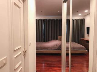 Bedroom with wooden floor and mirrored closet