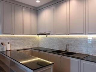 Modern kitchen with white cabinetry and under-cabinet lighting