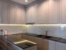 Modern kitchen with white cabinetry and under-cabinet lighting