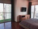 Spacious bedroom with large windows and balcony