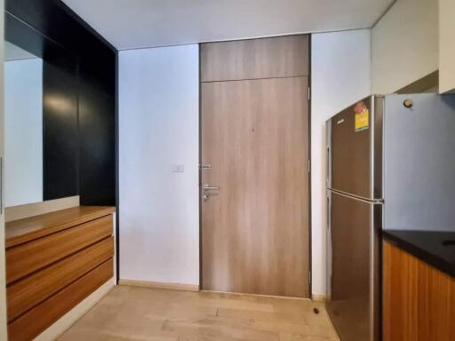 Entrance area with wooden door and storage units