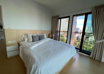 Spacious bedroom with a large bed and balcony