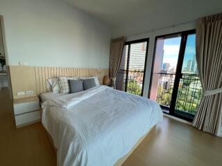 Spacious bedroom with a large bed and balcony