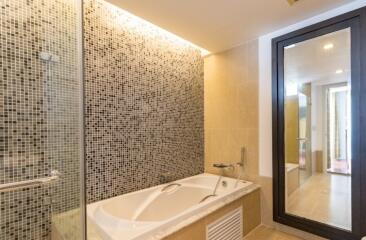 Modern bathroom with glass mosaic tiles and bathtub