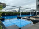 Modern rooftop swimming pool with city skyline view