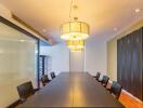 Spacious modern meeting room with long table and hanging lights