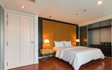 Modern bedroom with hardwood floors, a double bed, and ambient lighting