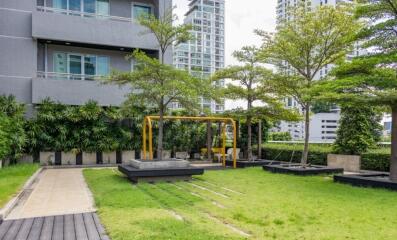 Modern apartment building with landscaped garden and seating area