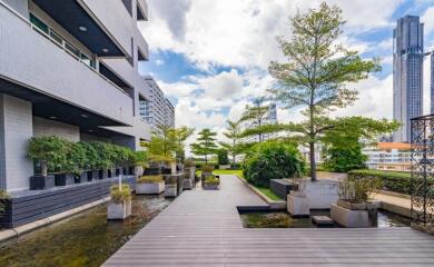 Modern building courtyard with greenery and water features