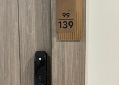 Modern apartment door with electronic lock and apartment number 99/139