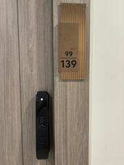 Modern apartment door with electronic lock and apartment number 99/139