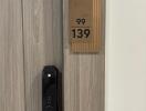 Modern apartment door with electronic lock and apartment number 99/139