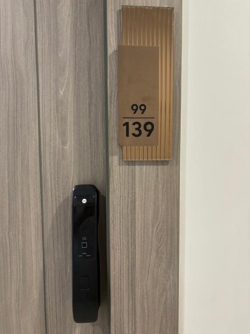 Modern apartment door with electronic lock and apartment number 99/139