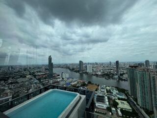 view from high-rise building with pool overlooking cityscape and river