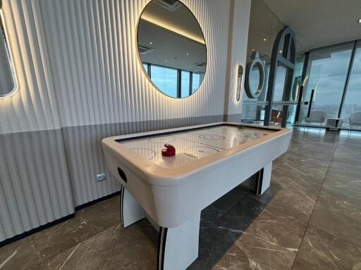 modern recreational room with an air hockey table