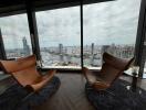 Modern living room with floor-to-ceiling windows and city view