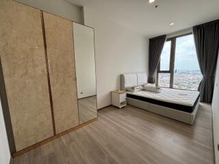 Modern bedroom with large window and city view