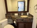 Modern bathroom with granite countertops and large mirror