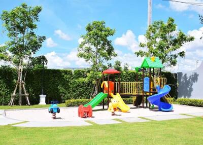 Playground with various play structures and greenery