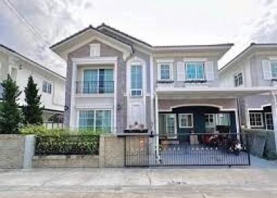 Modern two-story residential house with garage and garden