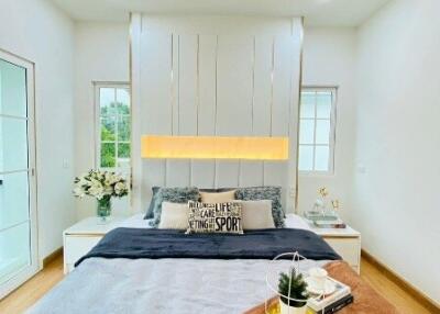 Modern bedroom with bed, side tables, and decorative elements