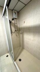 Shower area in bathroom with water heater