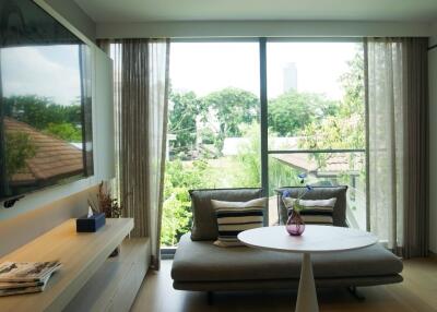 Cozy living room with large window and greenery view