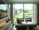 Cozy living room with large window and greenery view