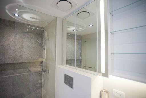 Modern bathroom with glass shower and mirrored cabinets