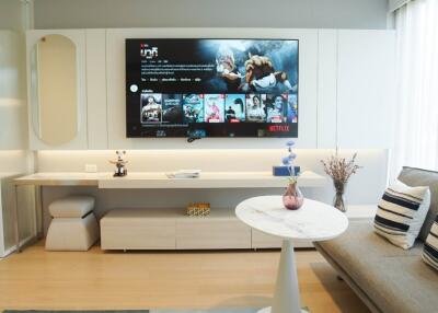 Modern living room with wall-mounted TV and contemporary decor