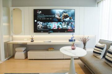 Modern living room with wall-mounted TV and contemporary decor