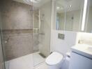 Modern bathroom with glass-enclosed shower and white fixtures