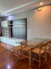 Modern dining area with glass table and wooden chairs