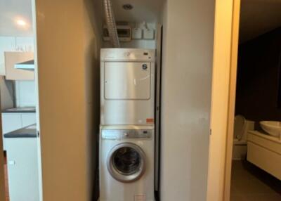 Compact laundry area with stacked washer and dryer in a closet