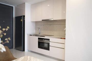 Modern kitchen with white cabinetry and stainless steel appliances