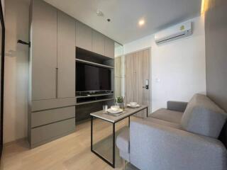 Modern living room with grey furniture and built-in storage